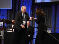 39 Awards Luncheon  "Gary Benda presenting the WM2015 ASME Best Oral Presentation/Paper, ""Uncertainty in Decommissioning, the Benefits of 3D Simulation"" – Track 9, Special Topics & Multi-Track Crosscutting Technology Topics to Sabrine Idihia with OREKA Solutions (Ms. Idihia accepted the award on behalf of Lawrence Wharmby and Luc Ardellier with OREKA Solutions) "